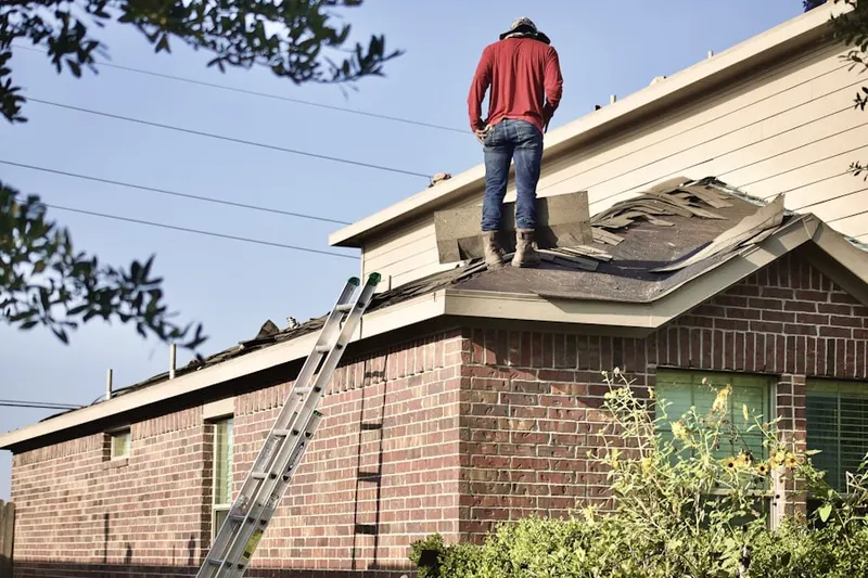Professional roofer working on a residential roof in Stone Harbor